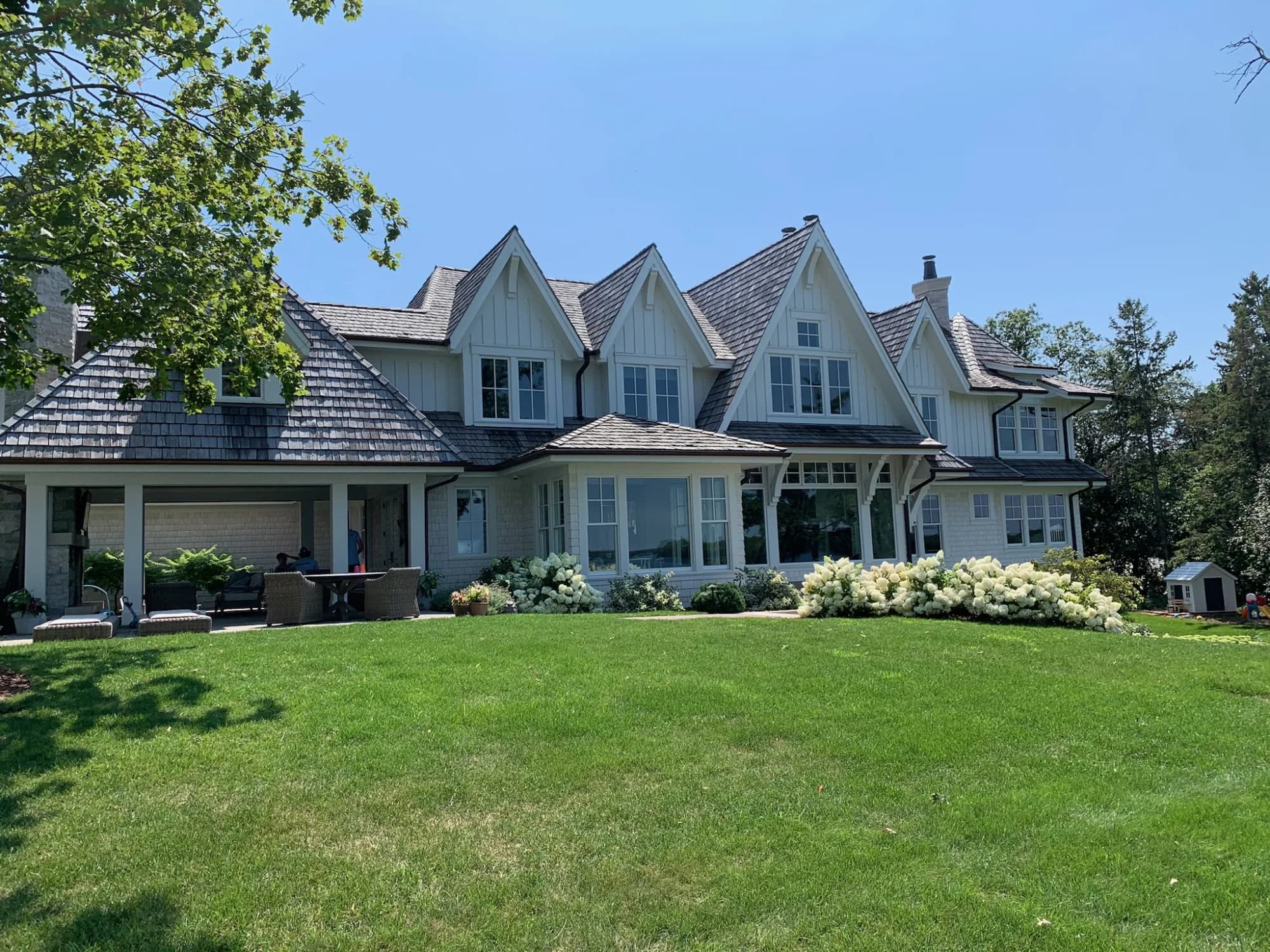 Shingle-style Twin Cities estate with gleaming exterior windows — pure water cleaning, not a ladder in sight