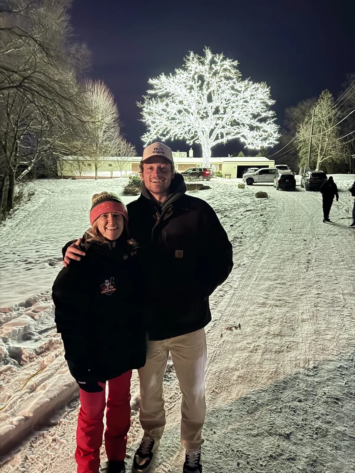 Fritz and his mom at the Bloomington Lighted Oak on the December 7 reveal night, fully lit for the first time as the news crew filmed