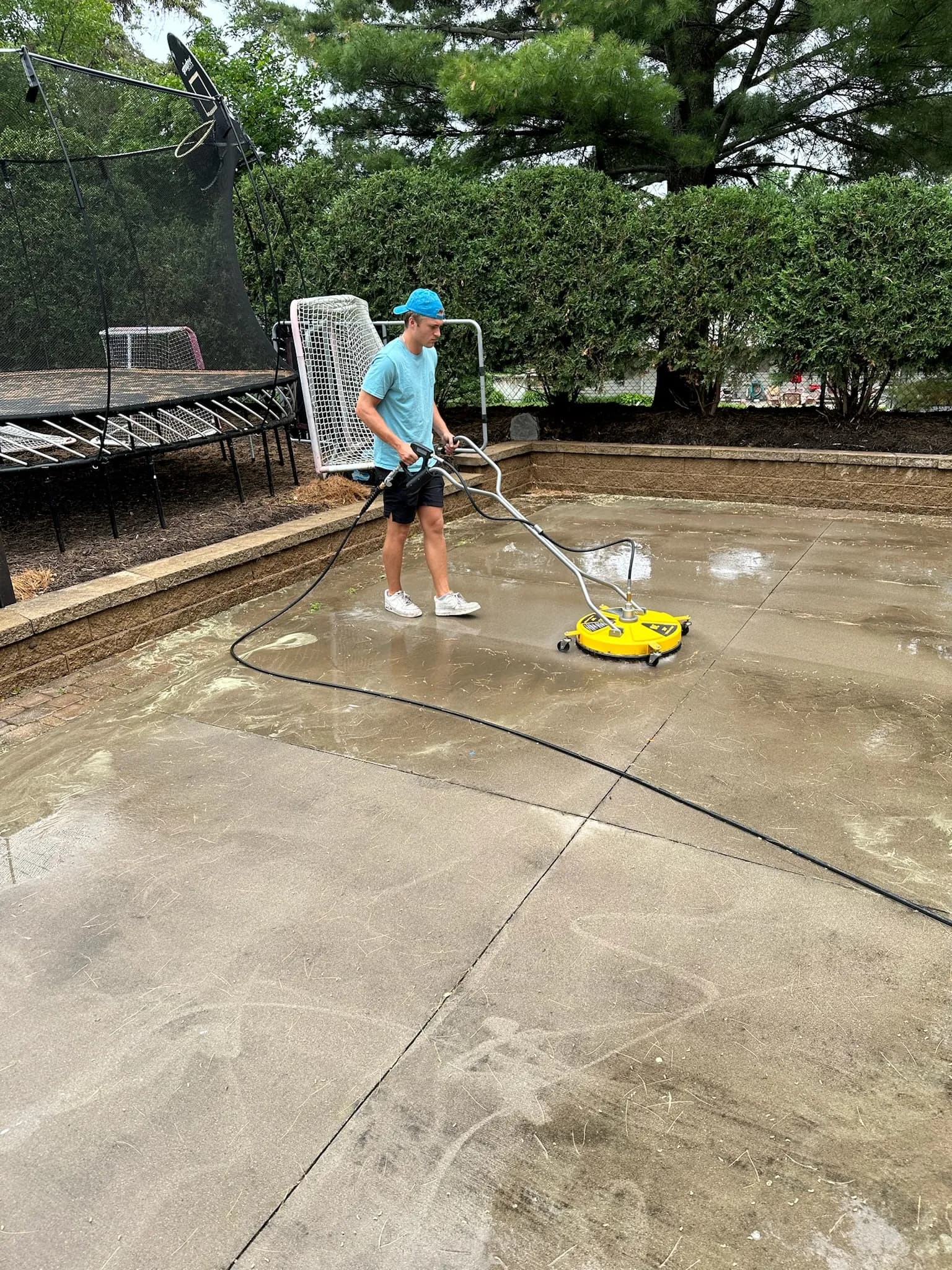 Pressure washing a backyard sport court with a rotary surface cleaner