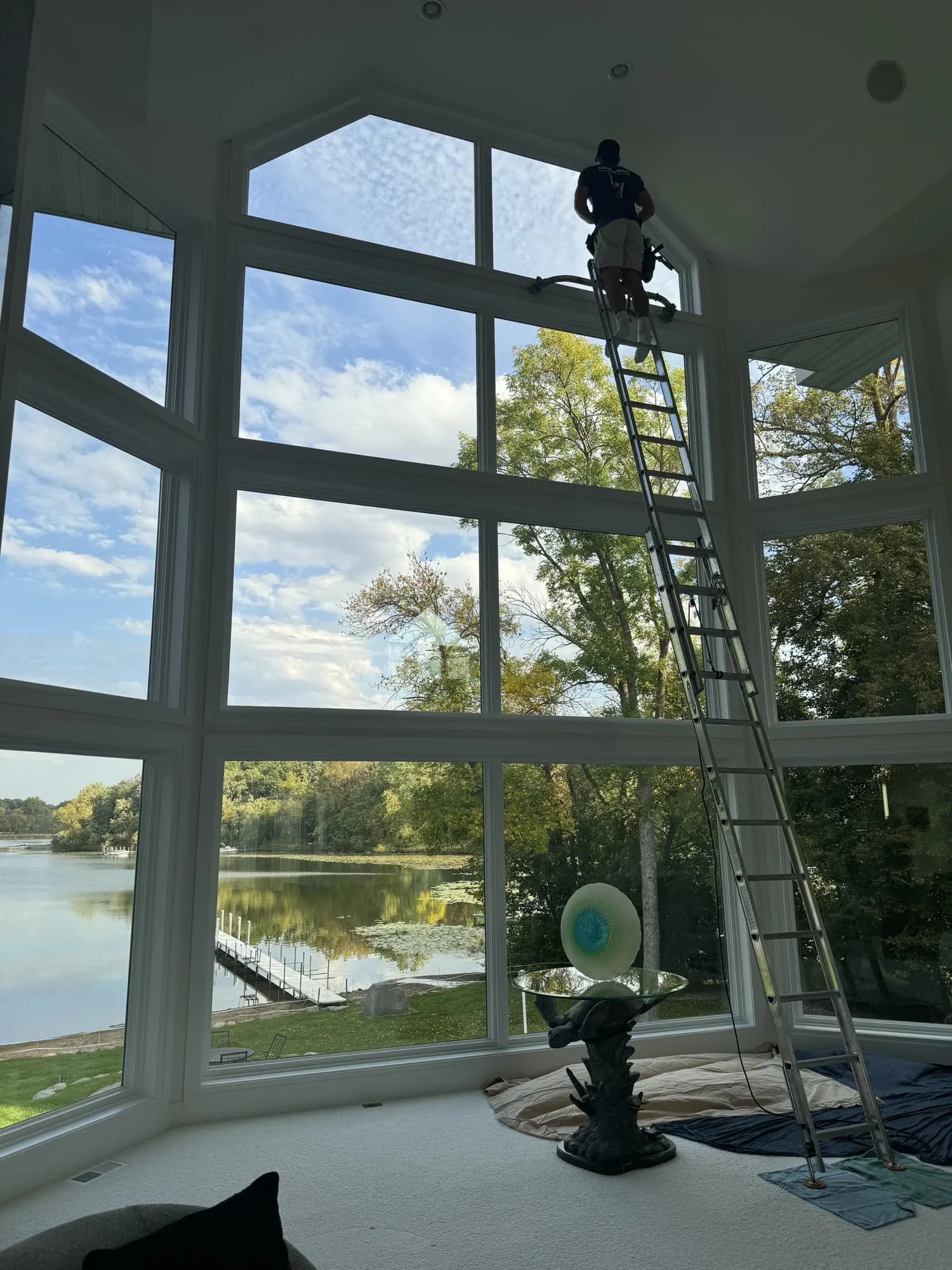 Spotless floor-to-ceiling lake-view windows after cleaning — bright great room, Twin Cities MN
