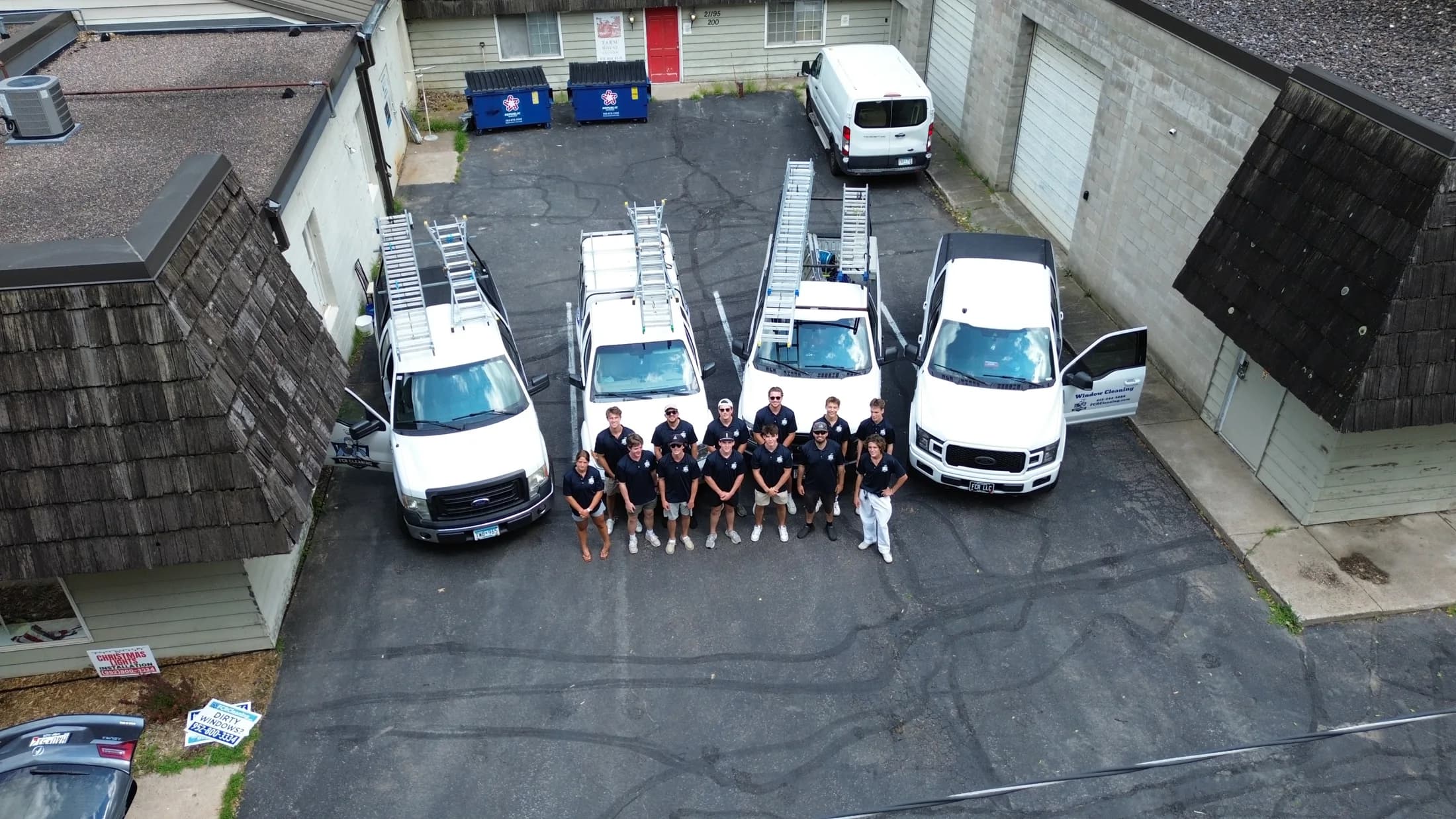 Drone view of the full FCR Cleaning crew and ladder-racked truck fleet at their Excelsior headquarters